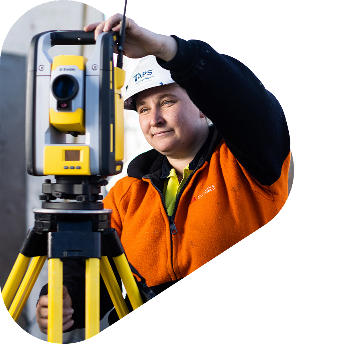 Mature age female surveyor onsite with surveying equipment